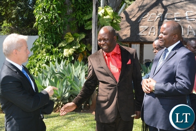 U.S Ambassador Eric Schultz(l) having a chat with His Royal Highness Chief Chamuka of Chisamba District(c) while Lands,Natural Resources and Environmental Protection Deputy Minister Davis Mwango(r) looks on during the swearing in ceremony for rural aquaculture promotion and linking income,food and environment project volunteers