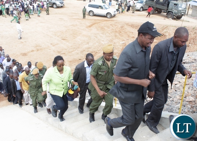 President Edgar Lungu (l) runs to climb the stairs to the Sioma Bridge during the official commissioning of the bridge built at a cost of K108.2million in Sioma District of Western Province