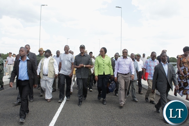 President Edgar Lungu (c) flanked by his entourage tours the Sioma Bridge built at a cost of K108.2million after officially commissioning it in Sioma District of Western Province,