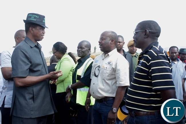 President Edgar Lungu (l) talks to Road Transport and Safety Agency (RTSA) Director Soko Zindaba (c) at the official commissioning of the Sioma Bridge built at a cost of K108.2million after officially commissioning it in Sioma District of Western Province