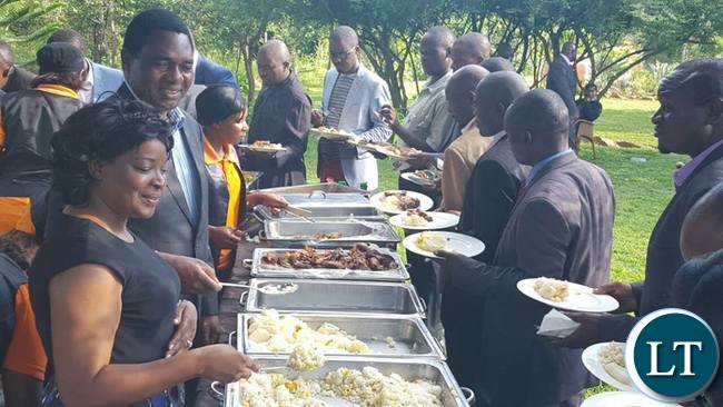 HH with his wife Mutinta serving clergy men and women after the prayer rally