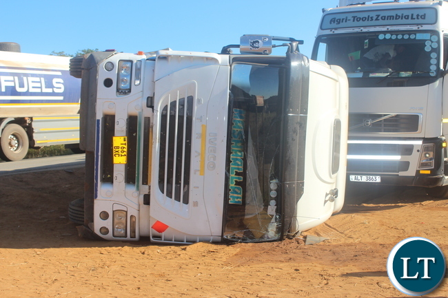 The driver of this truck and his lorry mate escaped with minor injuries after the truck toppled over when it got impounded by police at Ndabala check point in Serenje district