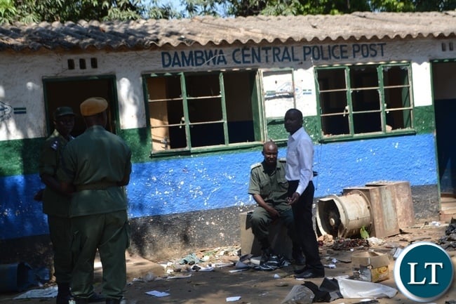 Police officer guarding remains of Dambwa Central Police Post which was attacked and damaged by irate Livingstone residents Police officer guarding remains of Dambwa Central Police Post which was attacked and damaged by irate Livingstone residents