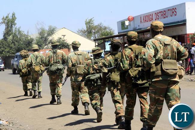 Soldiers from the Zambia Army patrolling compunds in Lusaka