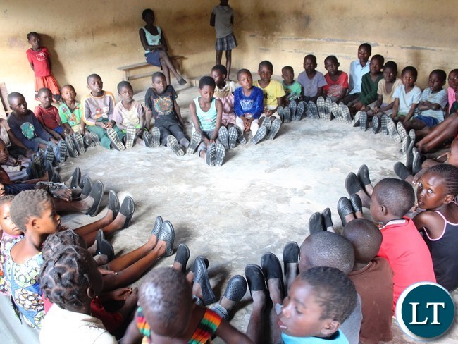 Part of the pupils who benefited from the over 200 shoes expresses their happiness by making the love shape for Ubulayo Charity Organization Founder Tasila Lungu at Chiba Community School in Kasama district .This was after she made a donation of shoes to over 200 for vulnerable and orphaned pupils at the school.