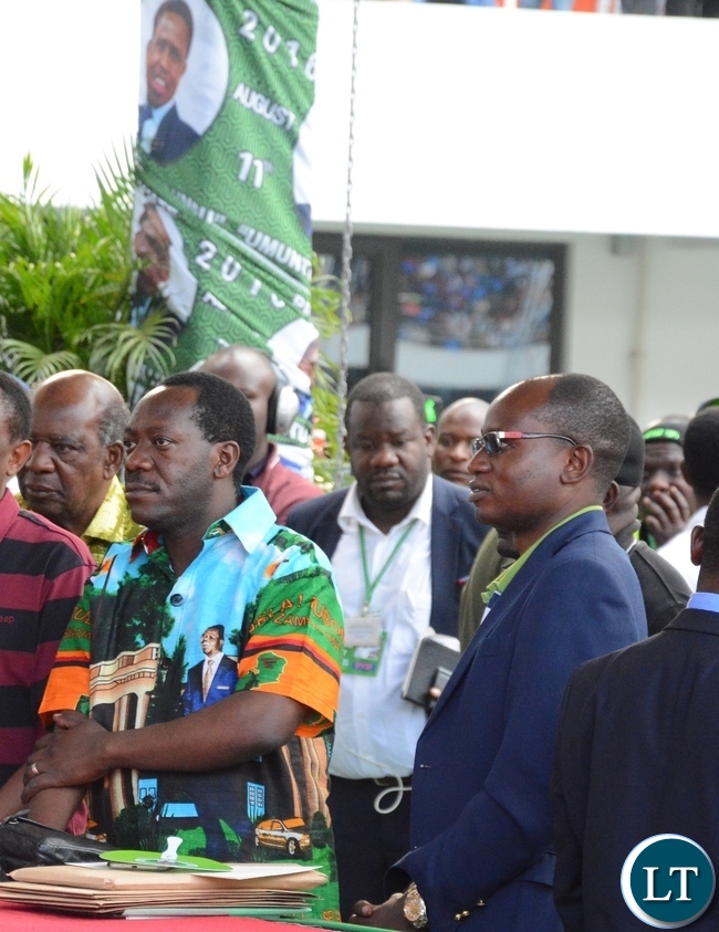 Special Assistant for Politics Kaiza Zulu and Special Assistant for Press and Public Relations Amos Chanda following the proceedings at the lunch of PF Campaign in the Heroes Stadium