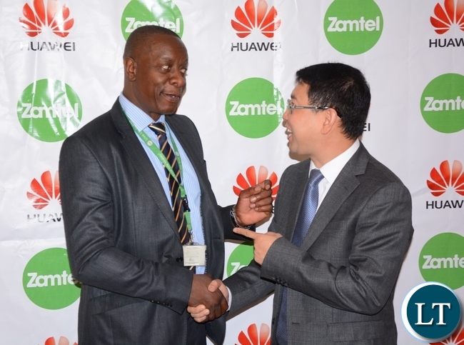 Zamtel CEO Mpanga Mwanakatwe and Managing Director Huawei Spawn Fan Wen having a light moment after Signing MOU of a Corporate Social Responsibility with Huawei Zambia provided 200, 000 USD and Zamtel Commitment to spend K2 million
