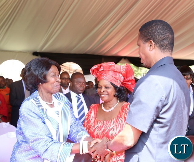 President Edgar Lungu(r) being welcomed by Vice President Inonge Wina(l) while the First Lady Esther Lungu looks on during the celebration of Africa Freedom day at State House
