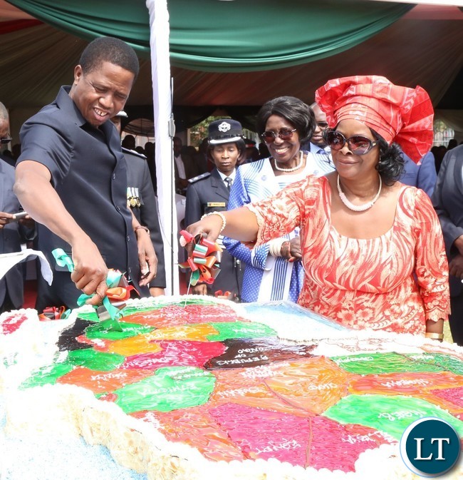 President Edgar Lungu(l) and his First Lady Esther Lungu(r) cutting the Africa Freedom day cake while the Vice President Inonge Wina looks on during the celebration of Africa Freedom