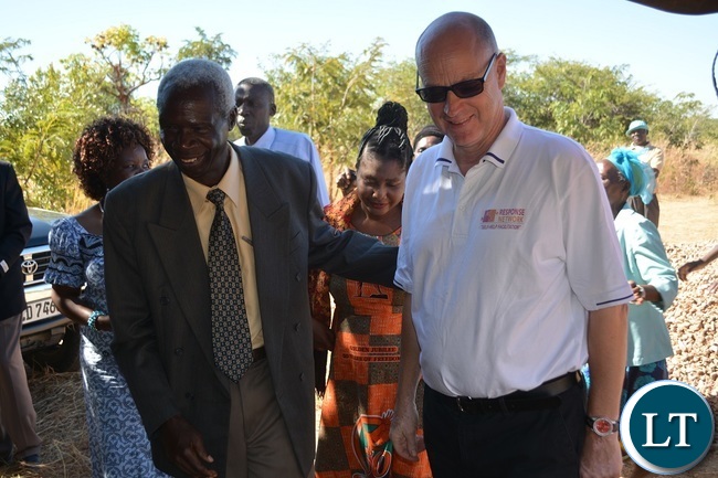 Chief Sipatunyana (Left) and Response Network Country Director Hakon Spigseth share a light moment during the Ground Breaking ceremony for Tore Schulze Memorial School in Zimba, Southern Province.