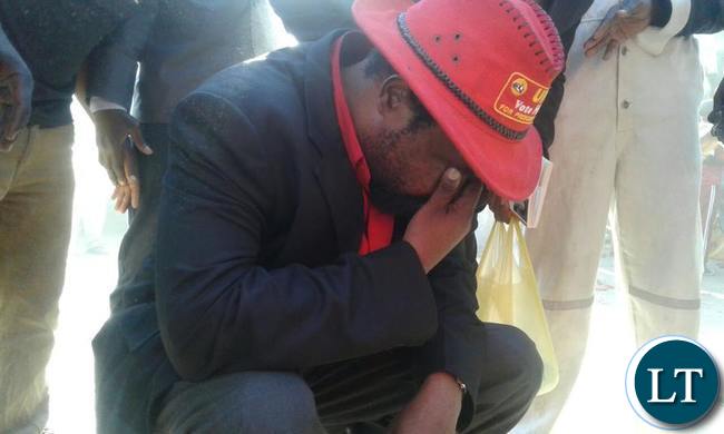 Dr Canicius Banda wipes his eyes after tear gas was thrown at the UPND youth rally