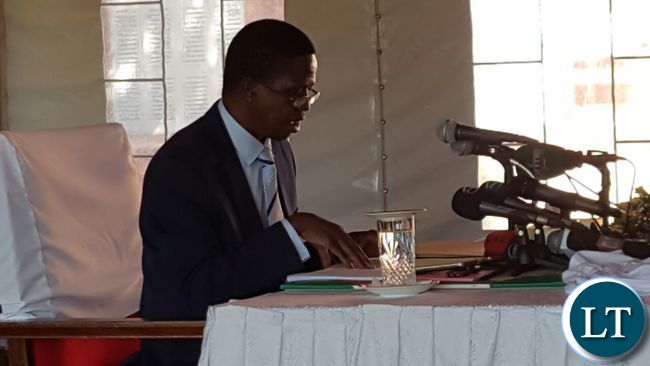 President Lungu reading through some documents during the news conference