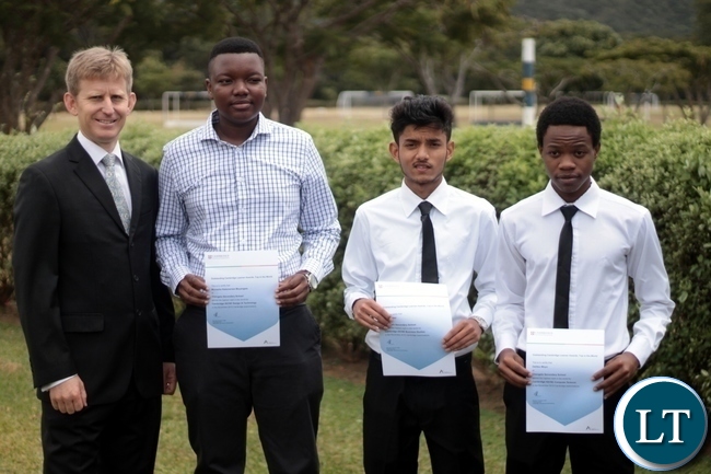 Principal Andrew Cowling with Munashe, Karan and Dalitso