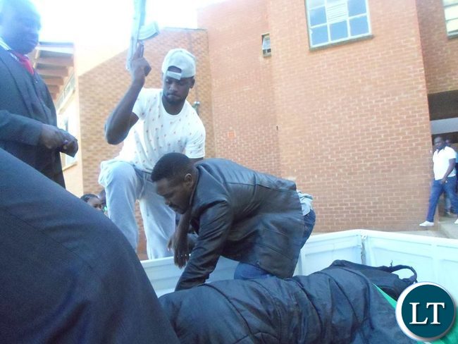 Ritual murder suspects bundled in the van after leaving court