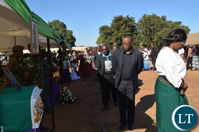 Ministry of General Education Spokesperson Hillary Chipango (in black T-shirt) pays his last respect during the burial of Hillcrest National Technical Secondary School accident victims at Villa Grounds in Livingstone.Picture by KELVIN MUDENDA