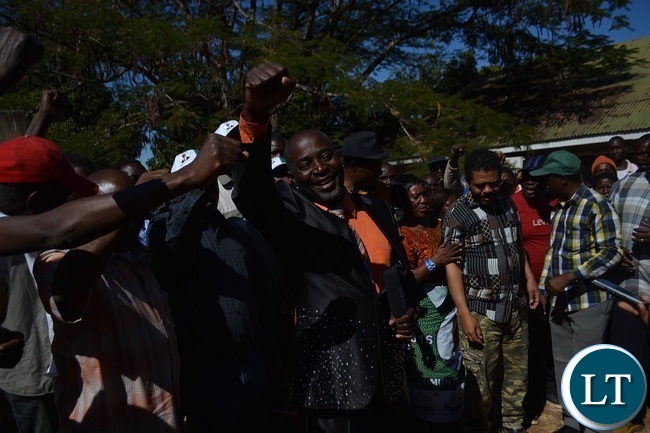 FORMER United Party for National Development (UPND) Zambezi ward Councilor Philimon Musonda flashes a PF symbol after defecting to the ruling party in Livingstone. Picture by KELVIN MUDENDA