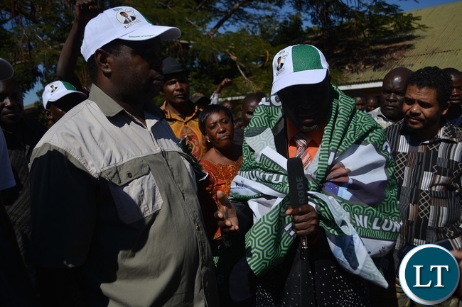 PF parliamentary candidate Omar Munsanje (left) welcomes FORMER United Party for National Development (UPND) Zambezi ward Councilor Philimon Musonda (Right in PF chitenge) during the defection ceremony in Livingstone .Picture by KELVIN MUDENDA