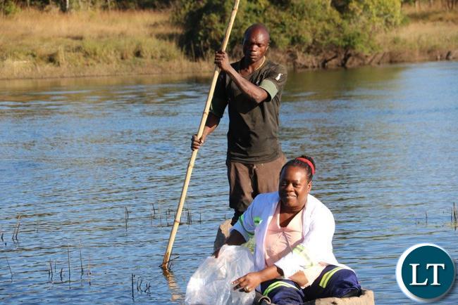 Konkola Copper Mines Plc Environmental Manager Glenda Mwandama releases Tilapia fingerlings into the Kafue River during the the commemoration of the 2016 World Environment Day