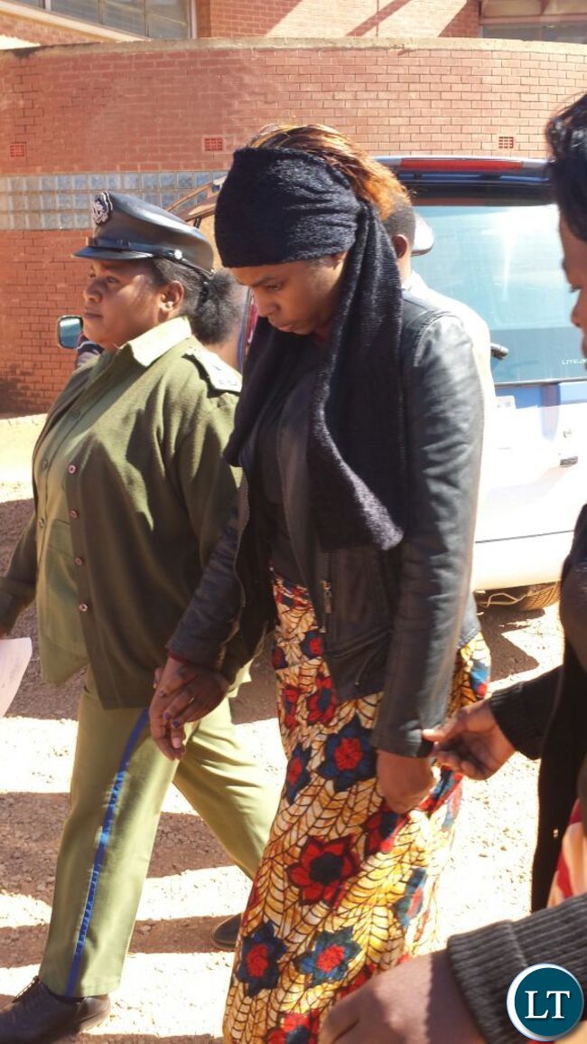 Murder suspect Precious being led back to the holding cell