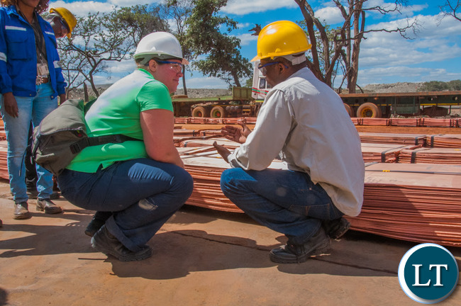 Head of the Office of the High Commission of Canada in Lusaka Amy Galigan inspects copper at First Quantum Minerals' Kansanshi mine.