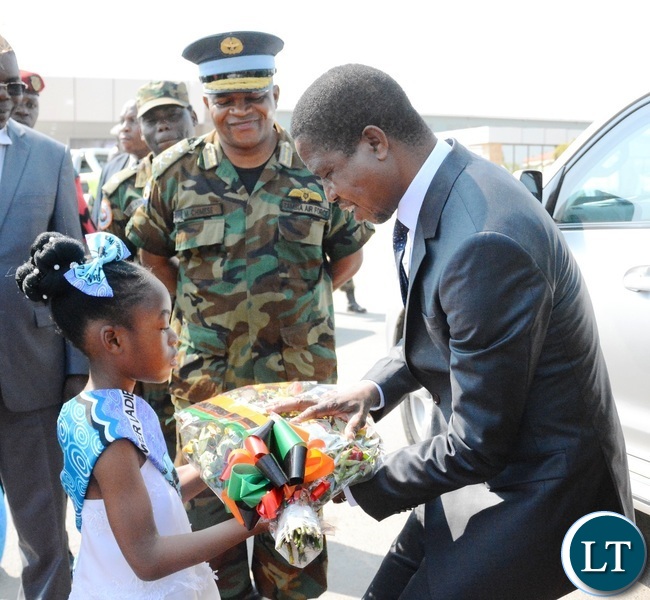 President Lungu(r) being welcomed by an 8 years old Zangi Njundu(l) at Zambia Air Force Headquarters during the official opening of Zambia Air Force Hospital