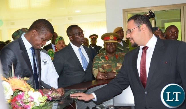 Sycom Africa Business Development Manager Mina Karas(r) shows President Lungu(l) the Digital login system for Patients at the reception at the State of the Art Zambia Air Force Hospital