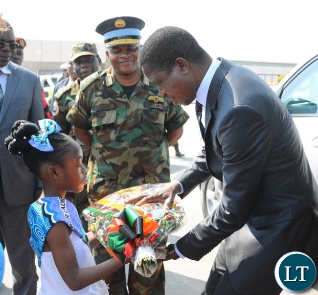President Lungu(r) being welcomed by an 8 years old Zangi Njundu(l) at Zambia Air Force Headquarters during the official opening of Zambia Air Force Hospital