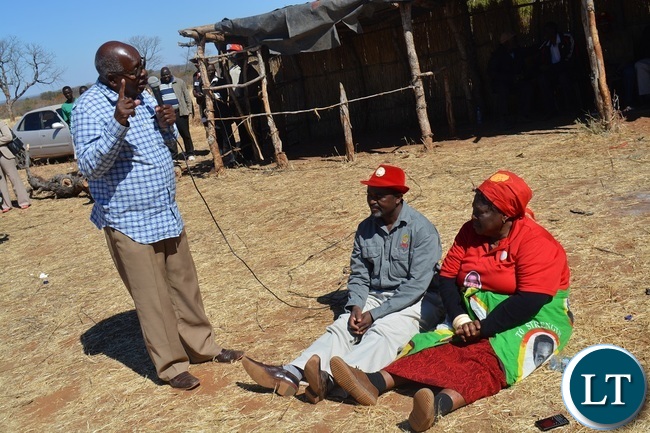 Former Southern Province Minister Daniel Munkombwe(holding microphone) counsels UPND Livingstone parliamentary candidate Mathews Jere(left in red hat) during a rally to drum up support for UPND Presidential,parliamentary and local Government candidates atMahululu clinic in Livingstone