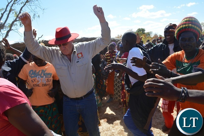 Chisekesi farmer and businessman Michael Couvaras dancing with UPND supporters during a rally to drum up support for UPND Presidential,parliamentary and local Government candidates atMahululu clinic in Livingstone