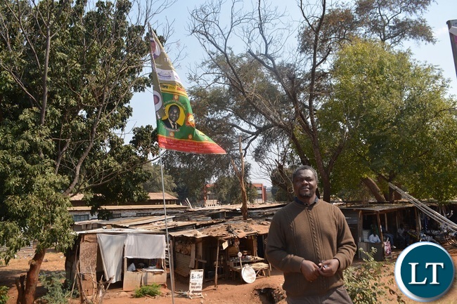 Jesuit Centre for Theological Reflection(JCTR) director Fr Leonard Chiti points at a PF/UPND flag at old town centre market in Livingstone Jesuit Centre for Theological Reflection(JCTR) director Fr Leonard Chiti points at a PF/UPND flag at old town centre market in Livingstone