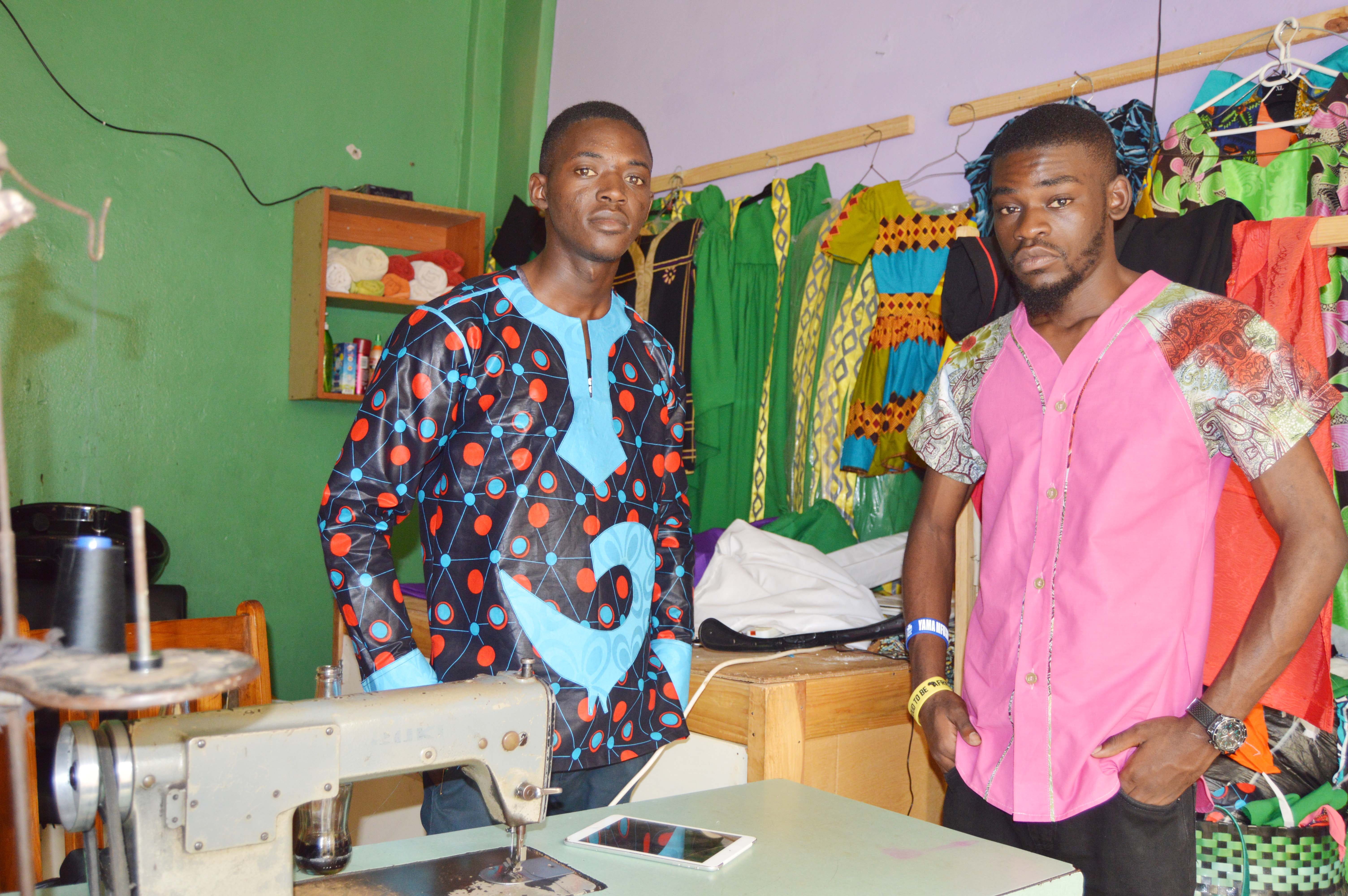 Designer and Tailors Timothy Mwandila and Mark Mafuleka (l) wearing their designs at their shop at Normead Market in Lusaka, Zambia. Picture by Hope Mkunte