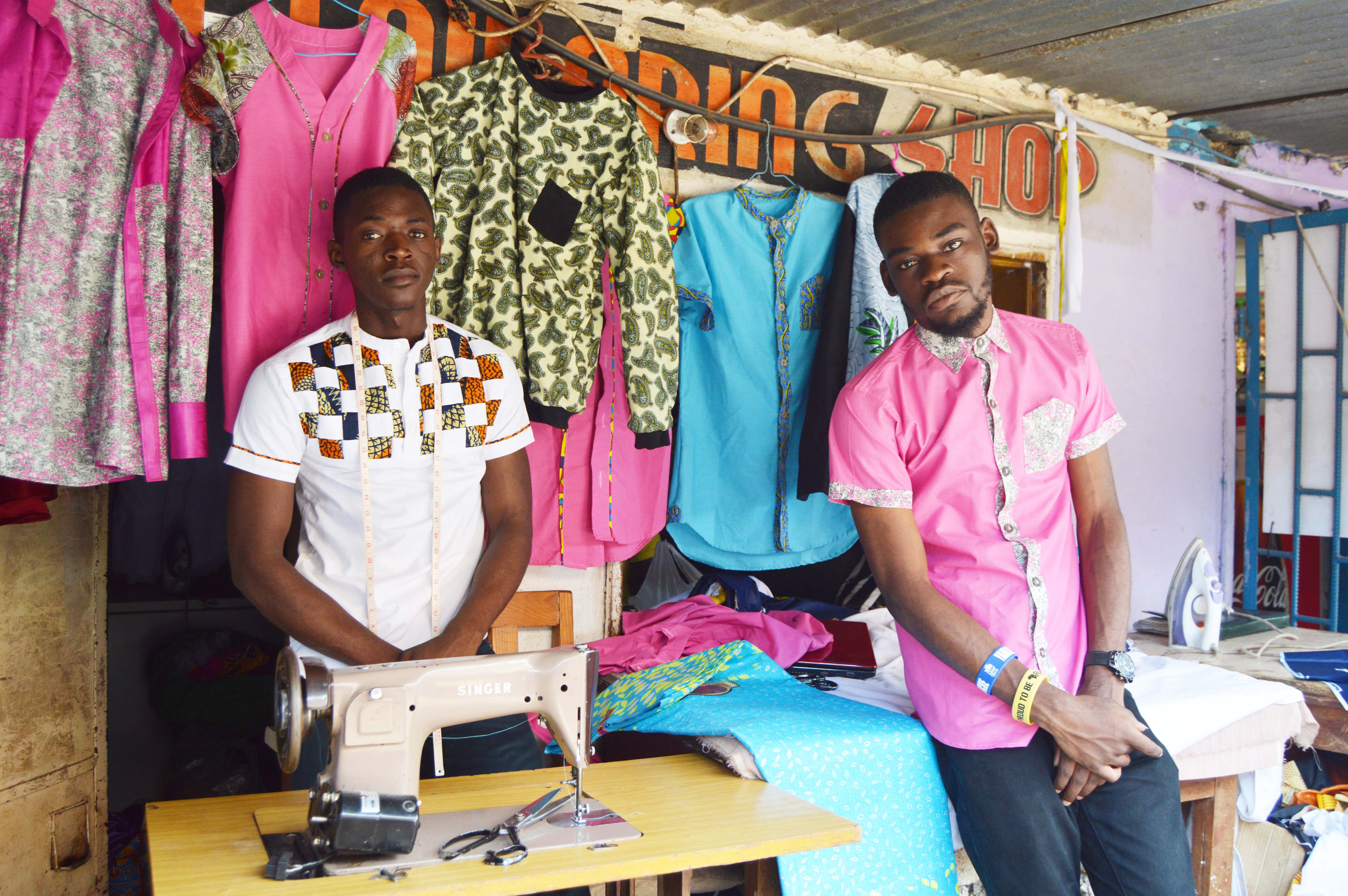 Designer and Tailors Timothy Mwandila and Mark Mafuleka take a break at their shop at Normead Market in Lusaka, Zambia. Picture by Hope Mkunte