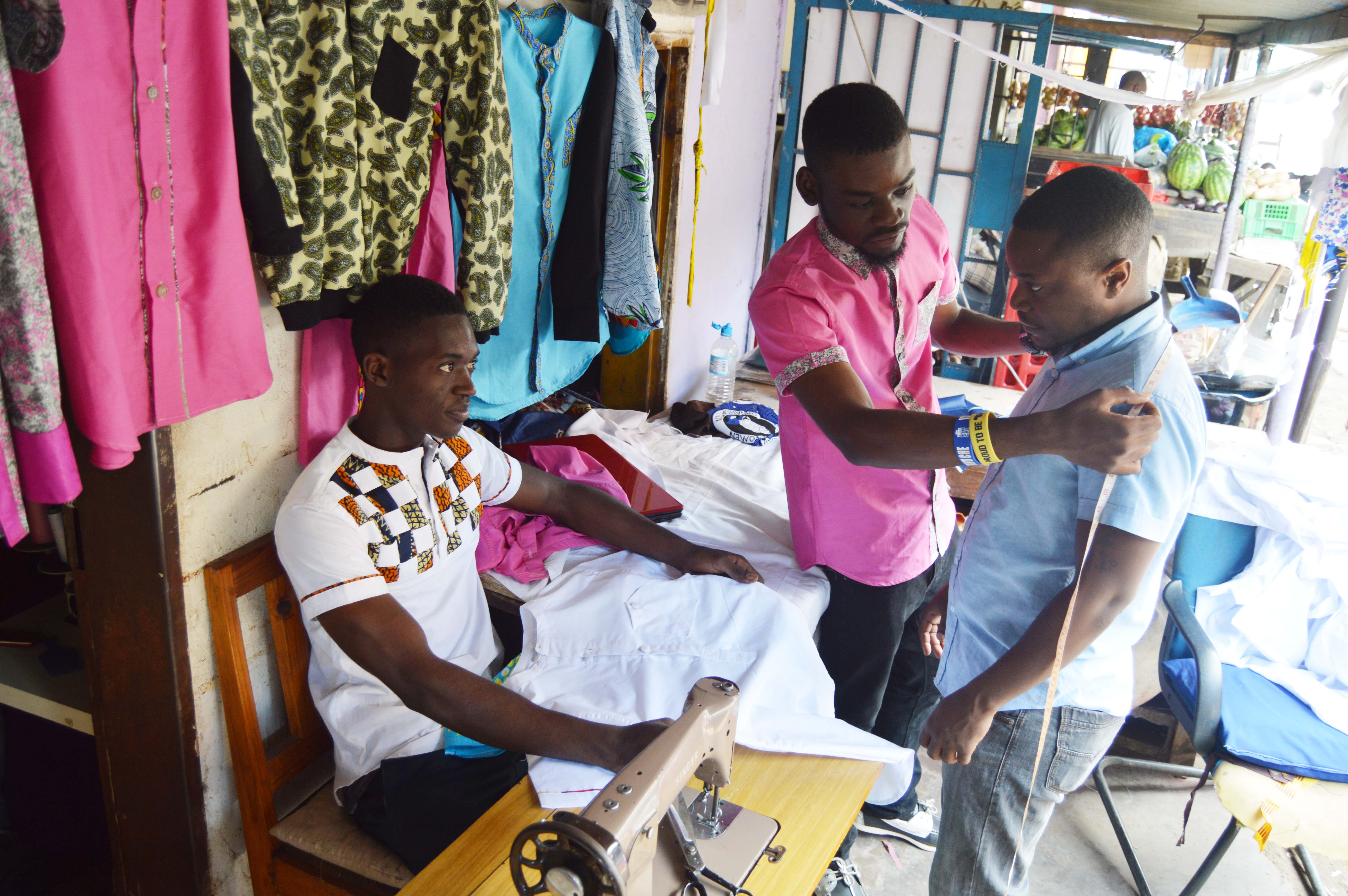 Designer and Tailors Timothy Mwandila and Mark Mafuleka working at their shop at Normead Market in Lusaka, Zambia. Picture by Hope Mkunte