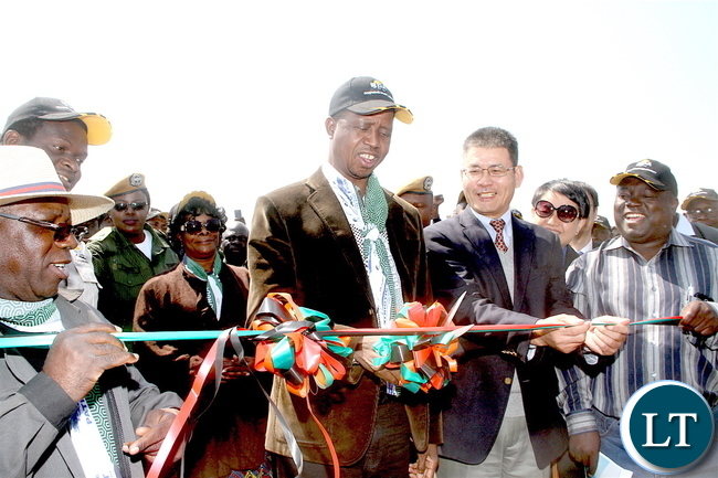 President Lungu cutting the ribbon with Chinese Ambassador to Zambia Yang Youming as First Lady Esther Lungu and Works and Supply minister Yamfwa Mukanga (r) looks on during the commissioning of Mansa-Luwingu Road in Luwingu on Monday, July 18,2016 –Picture by THOMAS NSAMA