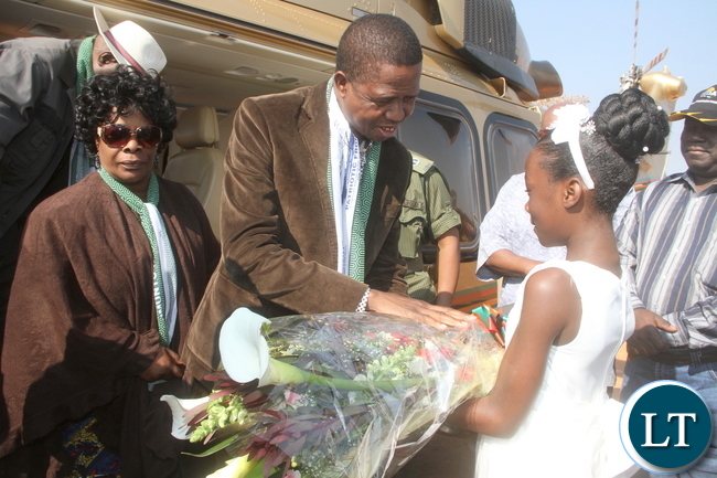 President Lungu receives a flower from Jenince Munyimba as First Lady Esther Lungu looks on on arrival in Luwingu for the Commissioning of Mansa Luwingu Road on Monday, July 18,2016 –Picture by THOMAS NSAMA