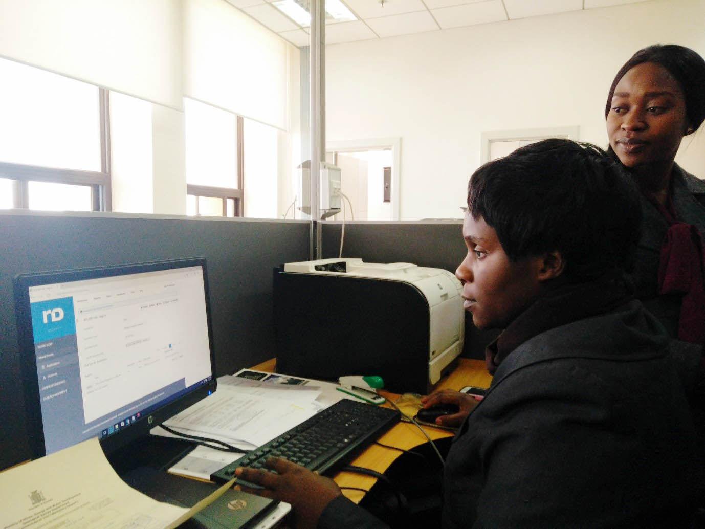 Stenographer Ms. Jean Mwenfa Simukonda gives out an export permit using the digital interface