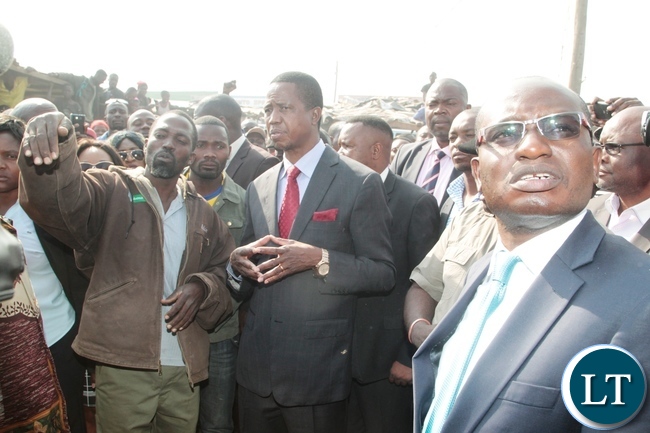 Shop keeper Special Sinjese explains to President Edgar Lungu on the burnt down shops at Bauleni Market