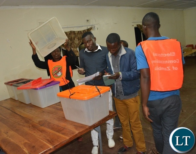 Electoral officers, agents and monitors inspecting the Ballot Boxes at Rainbow Africa polling station in Livingstone yesterday shortly before the opening of the Polls yesterday. Picture by BRIAN HATYOKA