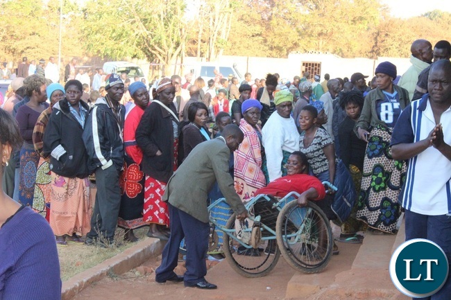A person living with disability being aided to cast her vote at Mchini Primary school in Chipata yesterday.Picture By JULIUS PHIRI A person living with disability being aided to cast her vote at Mchini Primary school in Chipata yesterday.Picture By JULIUS PHIRI