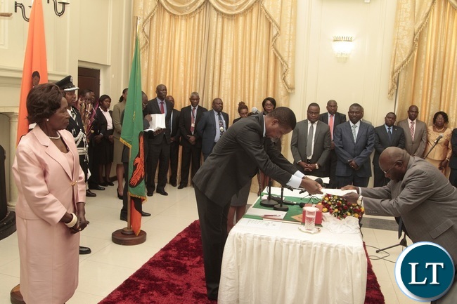 President Edgar Lungu flanked by Vice President Inonge receive latter of Oath from Newly appointed Minister of General Education Dennis Wachinga taking Oath before and during swearing in ceremony at State House