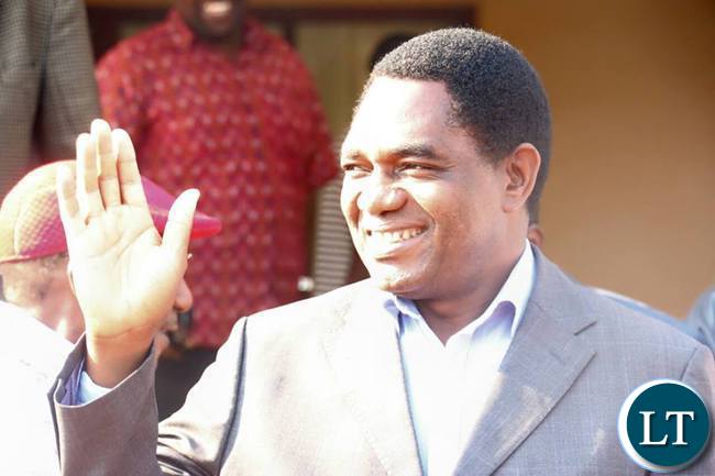 HH gestures to his supporters during a news briefing