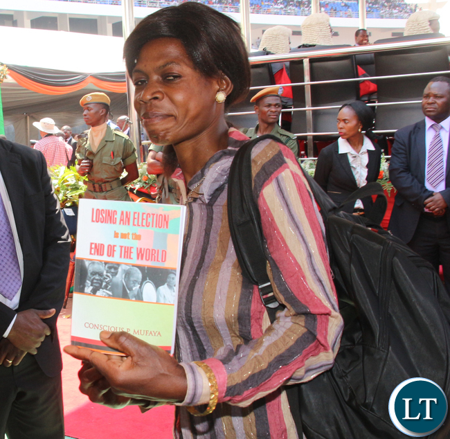 A Lady selling a book with a title "Loosing an Election in not the End of the World".
