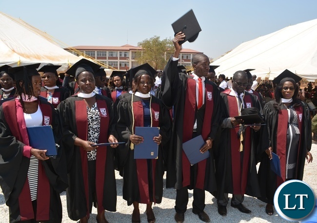 Rusangu University graduating student in Journalism and Communication degree, Onishias Kamana Maamba (third from far right) flashing his hat during the 10th Graduation Ceremony for Rusangu University in Monze Rusangu University graduating student in Journalism and Communication degree, Onishias Kamana Maamba (third from far right) flashing his hat during the 10th Graduation Ceremony for Rusangu University in Monze