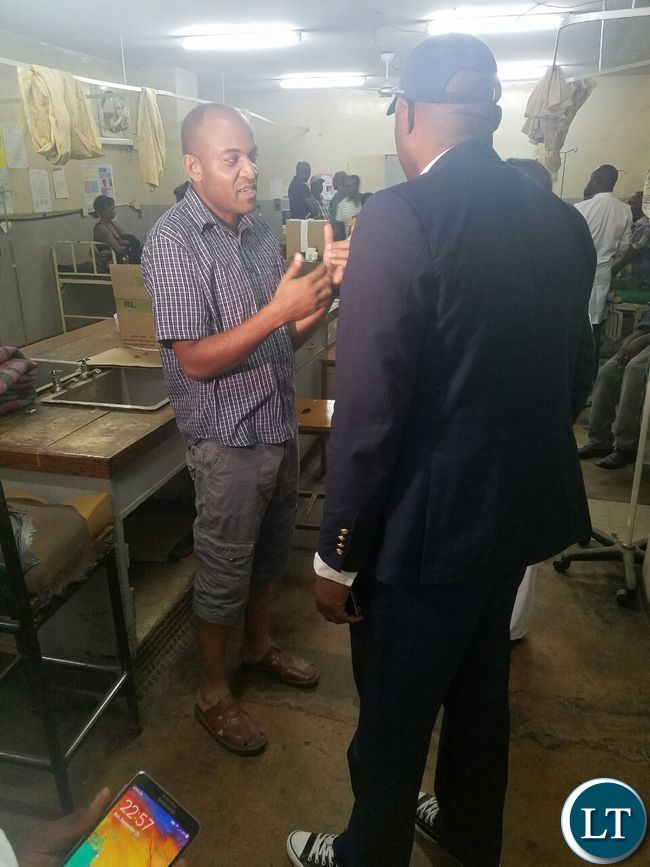 Mr Lusambo being briefed by Dr Joseph Musoboya