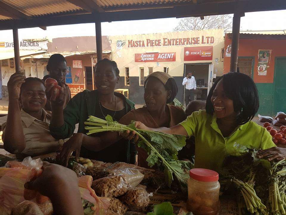 Mwansa Bwale at a market representing Zoona and telling women enterpreneurs about Zoonas campaign