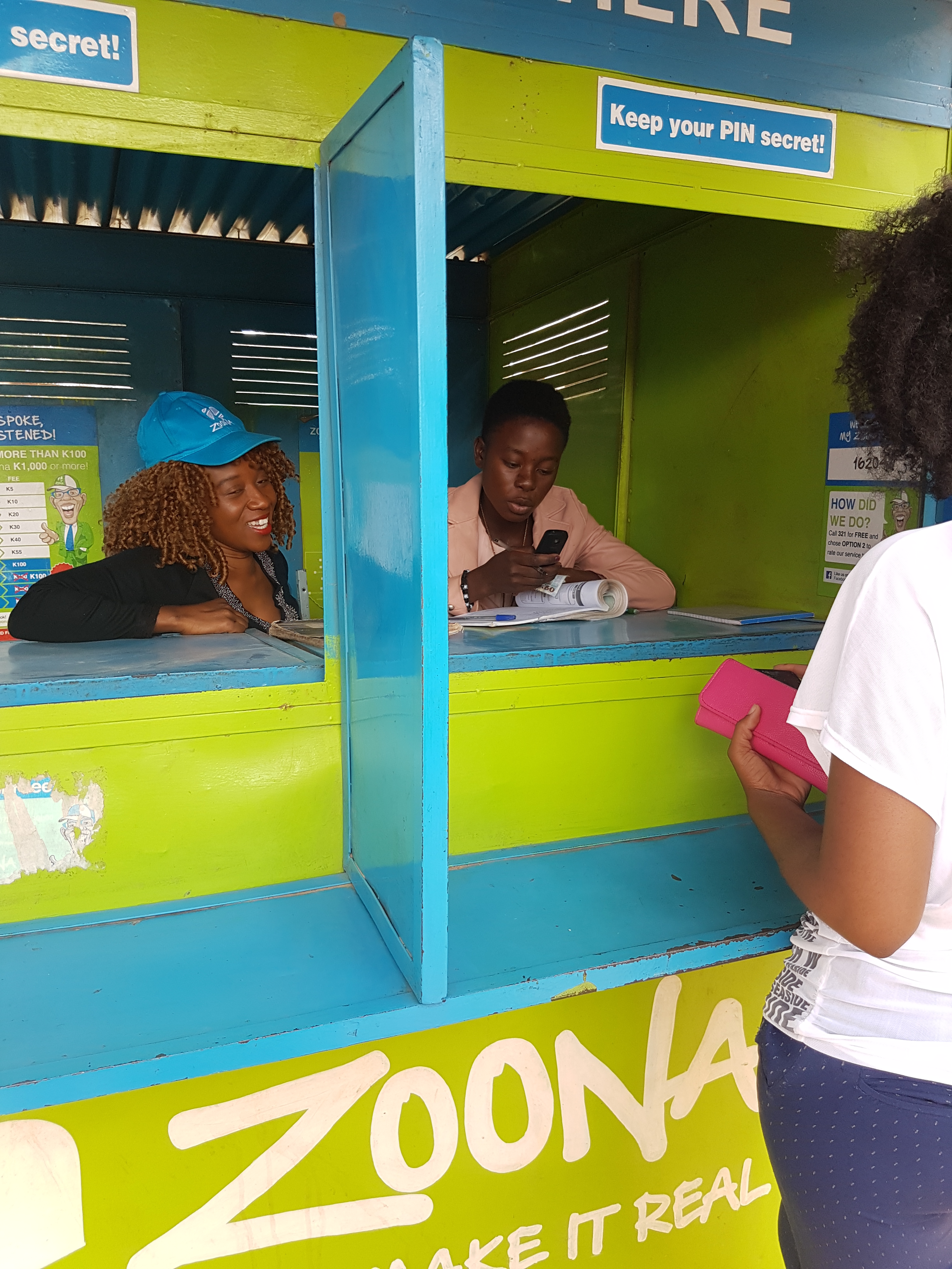 Mwansa bwale at a Zoona booth