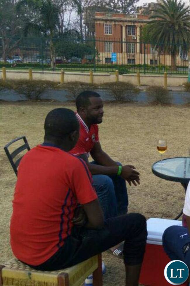 PF member Maxwell Chongo in deep conversation with his fellow PF youths outside the Supreme Court grounds