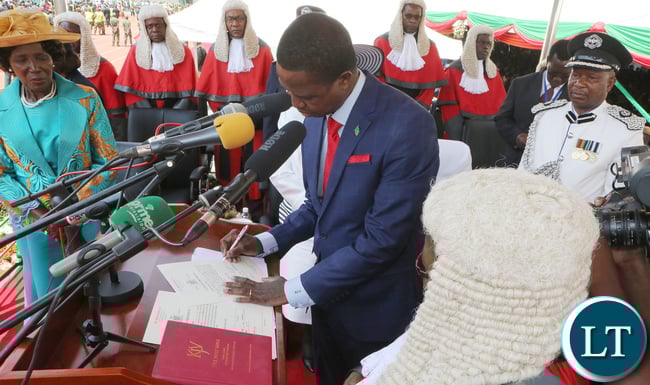 President Edgar Lungu Signing the Documents of Oaths while the chief Justice Irene Mambilima looks on