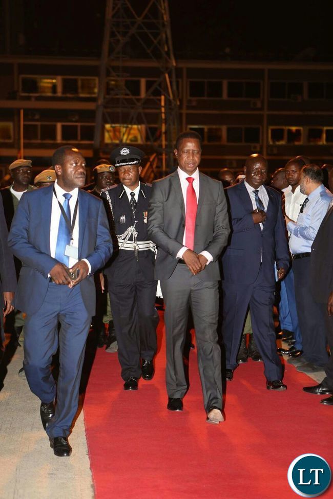 President Lungu flanked by his political adviser Kaizer Zulu departing for America