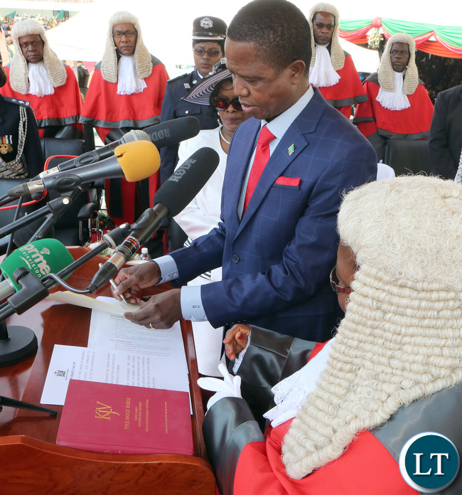 President Edgar Lungu Signing the Documents of Oaths while the chief Justice Irene Mambilima looks on President Edgar Lungu Signing the Documents of Oaths while the chief Justice Irene Mambilima looks on